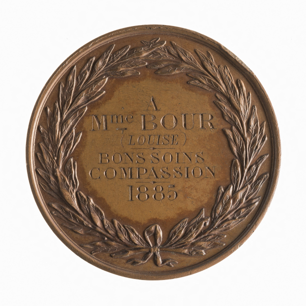 Bronze-Medaille mit Lorbeerkranz und der Aufschrift "Bons Soins Compassion" vor wei├čem Hintergrund.